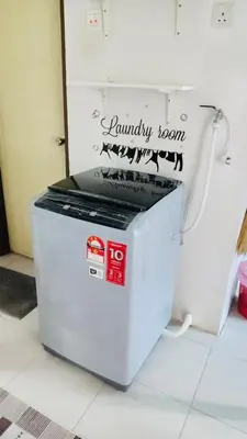 a small white refrigerator sitting on top of a floor at ZuLee Homestay in Lunas