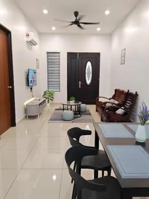 a living room with a ceiling fan and chairs at kkLee Homestay Taiping Tmn Spg Bersatu in Simpang