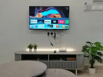 a flat screen tv hanging on a wall at kkLee Homestay Taiping Tmn Spg Bersatu in Simpang