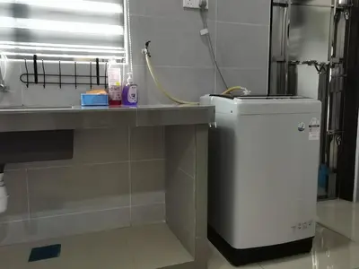 a bathroom with a sink and a washing machine at kkLee Homestay Taiping Tmn Spg Bersatu in Simpang