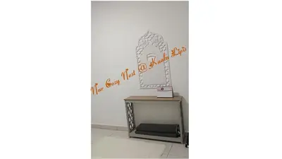 a dressing table with a mirror on a wall at Nur Cozy Nest Homestay in Kuala Lipis