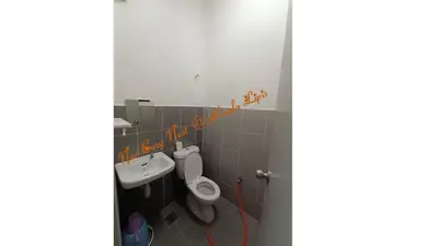 a bathroom with a toilet and a sink at Nur Cozy Nest Homestay in Kuala Lipis