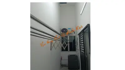 an open door into a room with orange signs on the wall at Nur Cozy Nest Homestay in Kuala Lipis