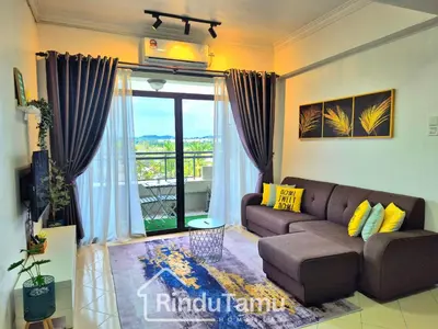 a living room with a couch and a large window at RinduTamu Homestay in Lumut