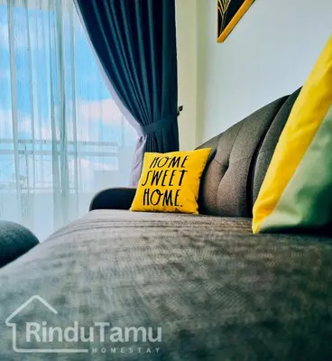 a bed with a yellow pillow on it with a window at RinduTamu Homestay in Lumut