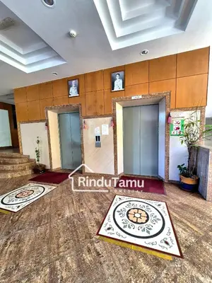 a lobby of an office building with three elevators at RinduTamu Homestay in Lumut