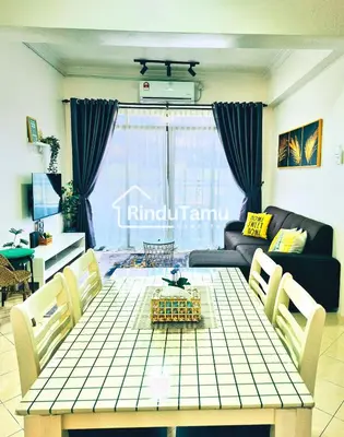 a living room with a table and a couch at RinduTamu Homestay in Lumut