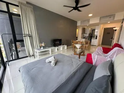 a bedroom with a bed and a living room at HOT & Modern 2BR Beacon Executive Suite, Georgetown in George Town