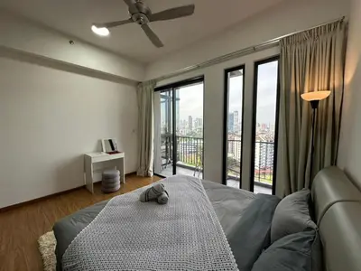 a bedroom with a bed and a large window at HOT & Modern 2BR Beacon Executive Suite, Georgetown in George Town