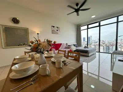 a living room with a table with plates and flowers on it at HOT & Modern 2BR Beacon Executive Suite, Georgetown in George Town