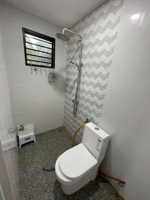 a bathroom with a toilet and a shower at Laman Serambi Homestay in Hutan Melintang