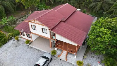 an overhead view of a house with a red roof at Laman Serambi Homestay in Hutan Melintang