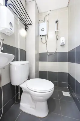 a bathroom with a toilet and a sink at Brinchang Highland Breeze Family 10 Pax Nest Unit Cameron Highland Clover Home 5-23A in Brinchang