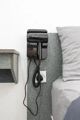 a phone attached to a wall next to a bed at Brinchang Highland Breeze Family 10 Pax Nest Unit Cameron Highland Clover Home 5-23A in Brinchang