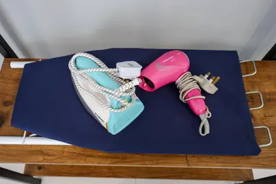 a blue table with a pink phone and a purse at Chill & Bloom Brinchang Cameron Highlands Clover Home M-02 in Brinchang