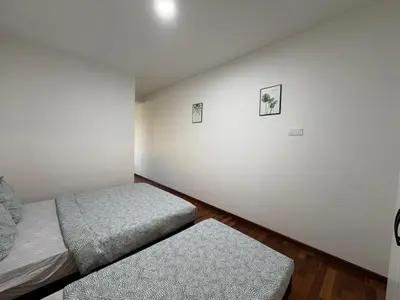 a bedroom with two twin beds and a wall at Penang Miami Beach in Batu Ferringhi