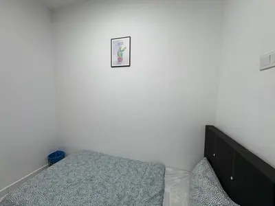 a bedroom with a bed and a picture on the wall at Penang Miami Beach in Batu Ferringhi