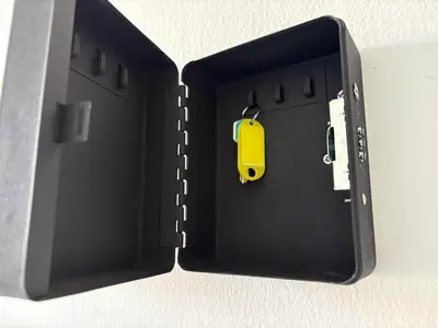 a black case with a yellow tag in it at Penang Miami Beach in Batu Ferringhi