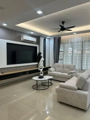 a living room with couches and a flat screen tv at Cozy Nook Stay Bukit Tinggi 2 in Kuang