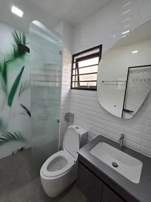 a bathroom with a toilet and a sink and a mirror at Cozy Nook Stay Bukit Tinggi 2 in Kuang