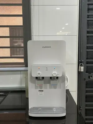 a white machine sitting on top of a table at Cozy Nook Stay Bukit Tinggi 2 in Kuang