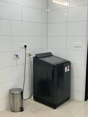 a small black machine in a room with a trash can at Cozy Nook Stay Bukit Tinggi 2 in Kuang