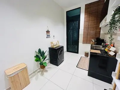 a kitchen with a black stove and a white floor at Ethereal Ipoh Homestay in Ipoh