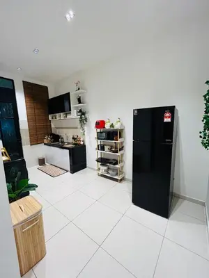 a kitchen with a black refrigerator and a white tile floor at Ethereal Ipoh Homestay in Ipoh
