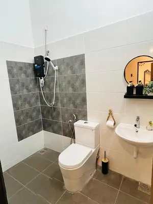 a bathroom with a toilet and a sink at Ethereal Ipoh Homestay in Ipoh