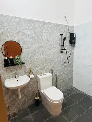 a bathroom with a toilet and a sink at Ethereal Ipoh Homestay in Ipoh
