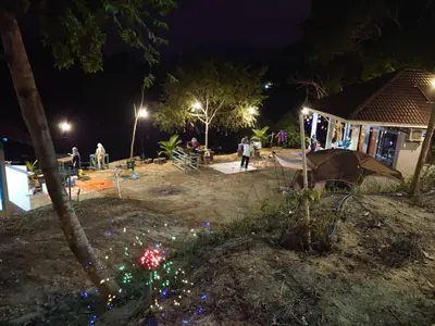 a group of people in a yard at night at TGB Buhayra CHALLET & CAMPSITE