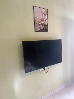 a flat screen tv hanging on a wall at TGB Buhayra CHALLET & CAMPSITE