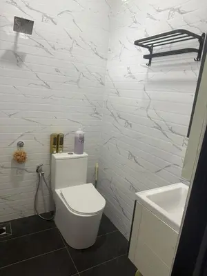 a white bathroom with a toilet and a sink at TGB Buhayra CHALLET & CAMPSITE