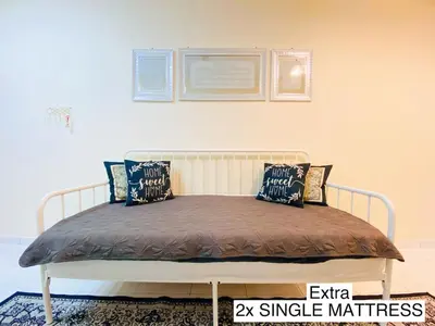 a bed with pillows on it in a bedroom at Homestay Bajet Teluk Intan in Teluk Intan