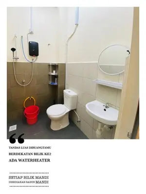 a bathroom with a toilet and a sink at Homestay Bajet Teluk Intan in Teluk Intan