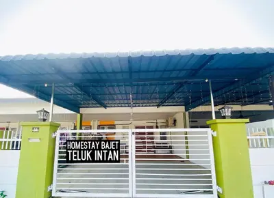 a building with a gate with a sign on it at Homestay Bajet Teluk Intan in Teluk Intan