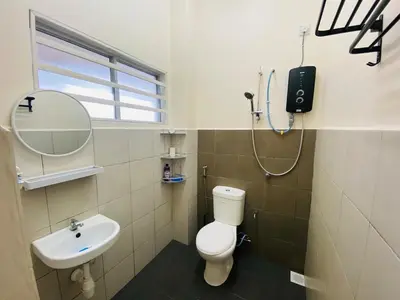 a bathroom with a white toilet and a sink at Homestay Bajet Teluk Intan in Teluk Intan