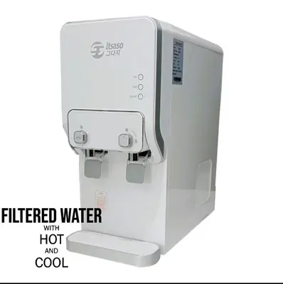a filtered water dispenser with a hot and cool sign at HomeStay Sungai Petani Kedah in Sungai Petani