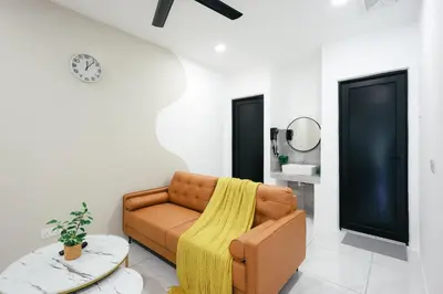 a living room with a couch and a table at Cameron Centrum CozyNest with Kids Playground Brinchang Clover Home A-1-15A in Brinchang