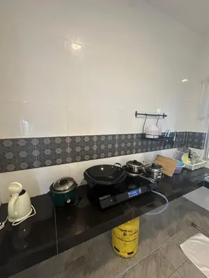 a kitchen with two pots and pans on a counter at Adik Aisyah homestay quintet 7-2 in Tanah Rata
