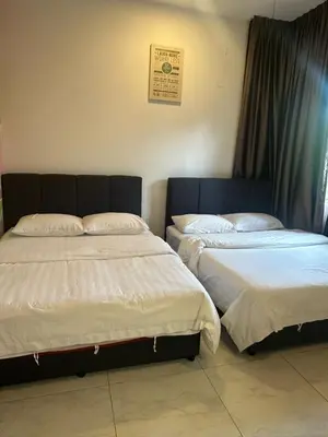 two beds sitting next to each other in a room at Adik Aisyah homestay quintet 7-2 in Tanah Rata