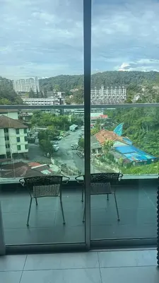 two benches in a room with a view of a city at Adik Aisyah homestay cameron quintet A3-7-3 in Tanah Rata