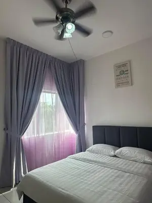 a bedroom with a ceiling fan and a window at Adik Aisyah homestay cameron quintet A3-7-3 in Tanah Rata