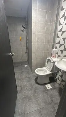 a bathroom with a toilet and a sink at Adik Aisyah homestay cameron quintet A3-7-3 in Tanah Rata