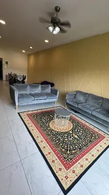a living room with a couch and a table on a rug at Adik Aisyah homestay cameron quintet A3-7-3 in Tanah Rata