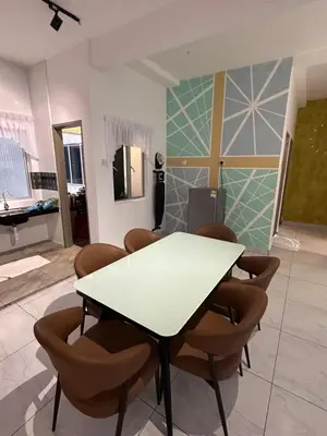a dining room with a white table and chairs at Adik Aisyah homestay cameron quintet A3-7-3A in Tanah Rata