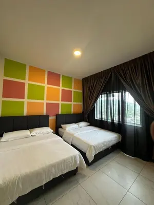 a bedroom with two beds and a colorful wall at Adik Aisyah homestay cameron quintet A3-7-3A in Tanah Rata