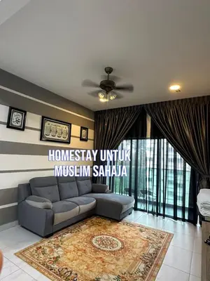 a living room with a couch and a rug at Adik Aisyah cameron homestay quintet A3-7-5 in Tanah Rata