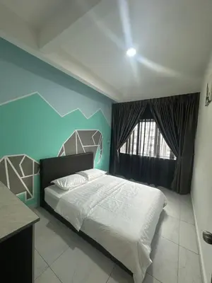 a bedroom with a white bed and a blue wall at Adik Aisyah cameron homestay quintet A3-7-5 in Tanah Rata