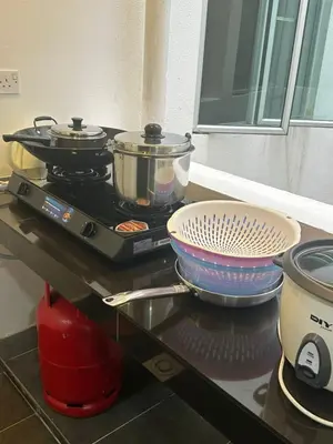a stove with two pots and pans on top of it at Adik Aisyah cameron homestay quintet A3-7-5 in Tanah Rata